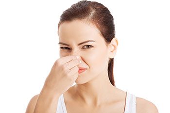 Woman Holding Nose Because Duvet Needs Washed